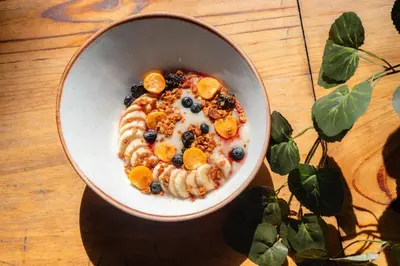 a bowl of cereal with fruit and granola at Naia Apart Hotel in Lima