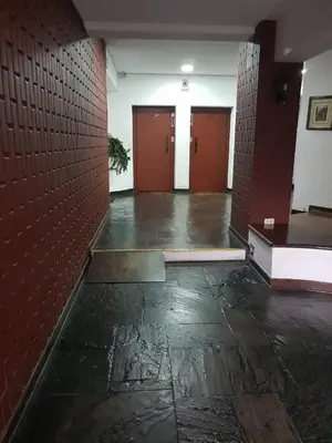 an empty hallway with red brick walls and doors at Maywa at Central Miraflores in Lima