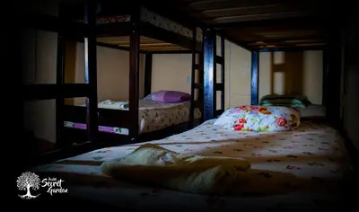 two bunk beds in a dark room with at Secret Garden in Cusco