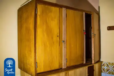 a wooden cabinet in the corner of a room at Secret Garden in Cusco