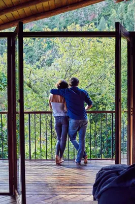 a man and a woman standing on a porch at Andenia Boutique Hotel, Sacred Valley in Urubamba