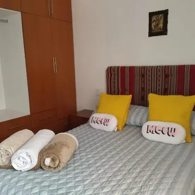 a bedroom with a bed with pillows on it at Piso de Kireyna in Cusco