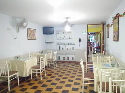a restaurant with tables and chairs in a room at Hotel Panamericano in Lima