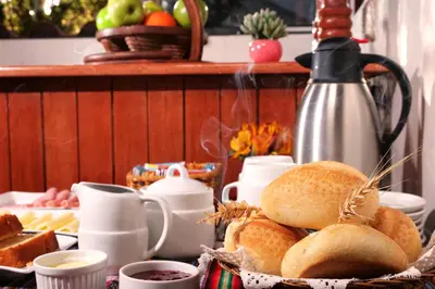a breakfast table with bread and cups of coffee at Welcome Cusco Hostel in Cusco