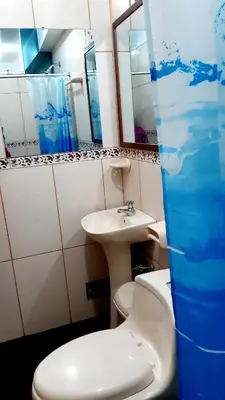 a bathroom with a toilet and a sink at Hostal Capac in Ayacucho