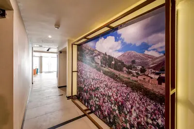 a large wall mural of flowers in a hallway at Arawi Miraflores Express in Lima