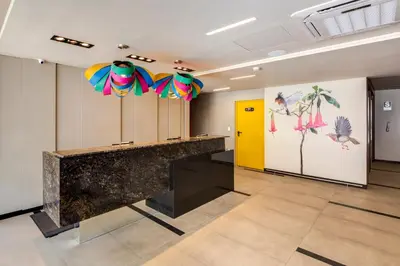 a lobby with a counter with colorful umbrellas at Arawi Miraflores Express in Lima