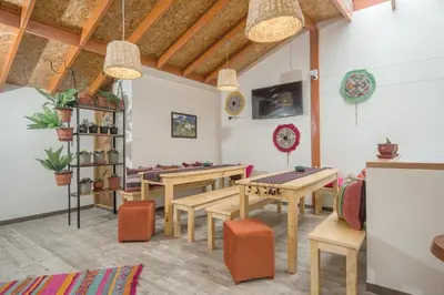 a living room with wooden tables and chairs at Casa Matara Boutique in Cusco