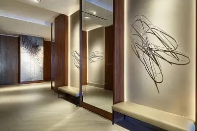a hallway with a glass wall with two chairs in it at AC Hotel by Marriott Lima Miraflores in Lima