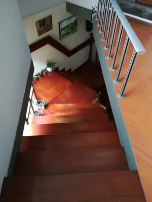 an overhead view of a staircase with wood flooring and stairs at Mini Departamento Tambo Huascar 2 in Lima