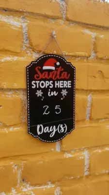 a sign that says santa stops here in days at Casa Montemira in Ica