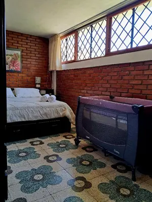 a bedroom with a bed and a tv in a room at Casa Montemira in Ica