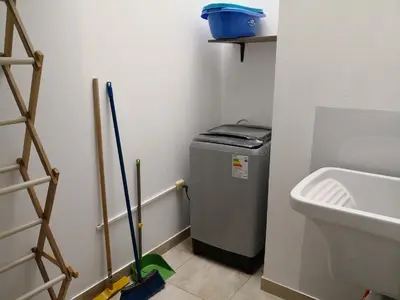 a bathroom with a small refrigerator and a sink at Departamento en el centro de San Borja (Rubens) in Lima