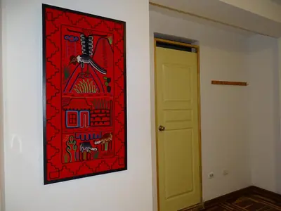 a picture hanging on a wall next to a door at Peruvian Family Hostal Miraflores in Lima