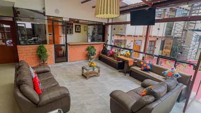 a living room with couches and chairs in a building at Andean Atoq Hostel in Cusco