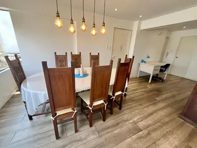 a dining room with a table and chairs at Céntrico Apartamento Parque Kennedy Miraflores in Lima