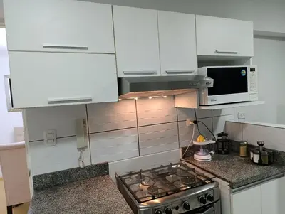 a kitchen with white cabinets and a stove top oven at MIRAFLORES APART-10Beds-11Persons-Pool-Grill-Garage-Near Kennedy Park in Lima