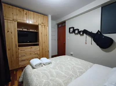 a bedroom with a bed with two towels on it at El Balcón del Sol in Cusco
