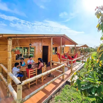 a group of people sitting on the porch of a house at Apart Hotel El Paraíso de Barranca in Barranca