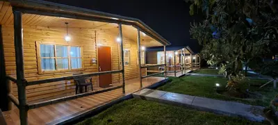 a wooden cabin at night with lights on it at Apart Hotel El Paraíso de Barranca in Barranca