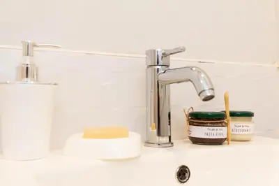 a bathroom sink with two faucets and a counter top at Casa 100% ecológica con vista a los glaciares andinos in Maras