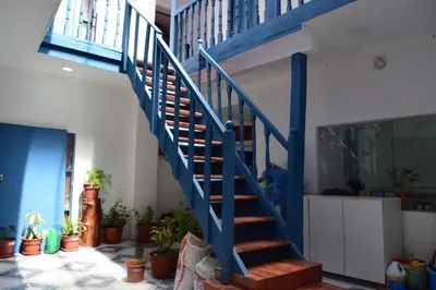 a blue staircase in a house with potted plants at Carlos Guest House 3 Cusco in Cusco