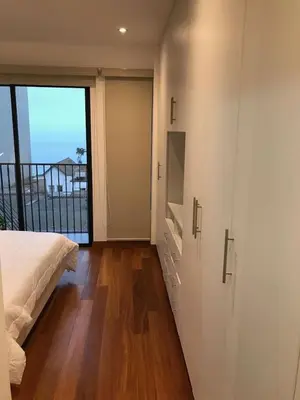 a bedroom with a bed and a large window at MLA apartments - Buenos Aires in Lima
