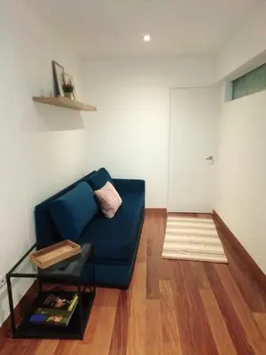 a living room with a blue couch and a table at MLA apartments - Buenos Aires in Lima