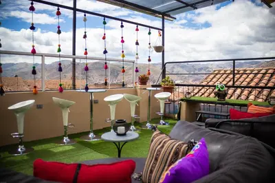 a living room with a view of the mountains at Home Garden Hotel in Cusco
