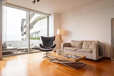 a living room with a couch and a chair at InkaHuset Miraflores Oceanfront in Lima
