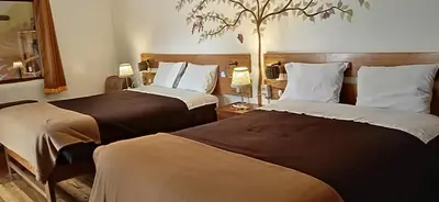 two beds in a hotel room with two at Casa Inka B&B in Ollantaytambo