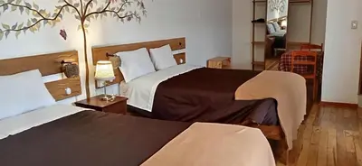 a hotel room with two beds in a room at Casa Inka B&B in Ollantaytambo