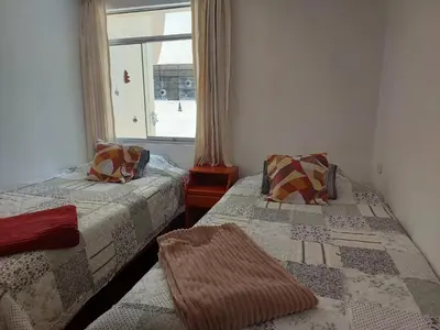 a bedroom with two beds and a window at Mandalas Cusco in Cusco
