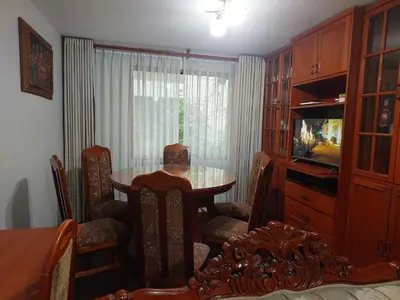 a dining room with a table and chairs and a television at Mandalas Cusco in Cusco