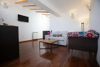a living room with a couch and a table at Tocuyeros Boutique Hotel in Cusco