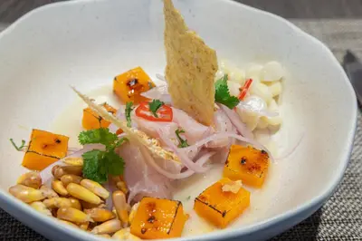 a white bowl of food with a sandwich and vegetables at Holiday Inn - Lima Miraflores by IHG in Lima