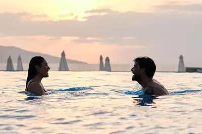 a man and a woman in the water at Casa Andina Select Paracas in Paracas