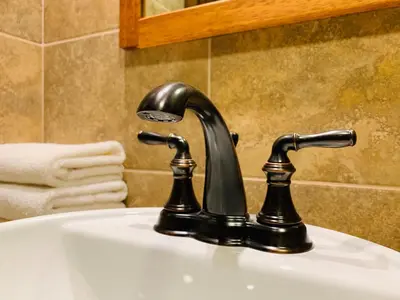 a bathroom sink with a black faucet at 1911 in Machu Picchu
