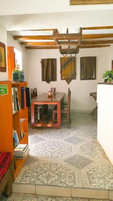 a living room with a table and a dining room at Casa Patacalle in Ollantaytambo