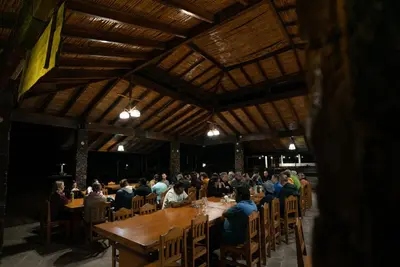 a large group of people sitting at tables in a restaurant at Hotel Puerto Inka in Chala