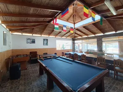 a pool table in a room with tables and chairs at Hotel Puerto Inka in Chala
