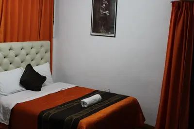 a bedroom with a bed with a towel on it at Imperial Golden House Inn in Cusco