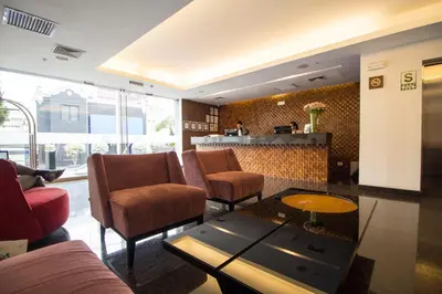 a living room with a couch and chairs and a table at Tierra Viva Miraflores Larco in Lima