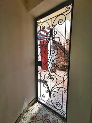 a door with a glass window with a staircase at Casa Durand in Cusco