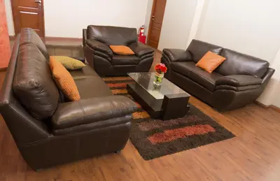 a living room with two leather couches and a coffee table at Hotel Inka Path in Lima