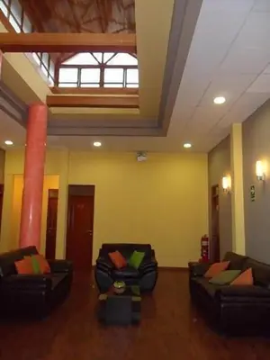 two couches in a large room with yellow walls at Hotel Inka Path in Lima