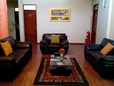 a living room with two leather couches and a coffee table at Hotel Inka Path in Lima