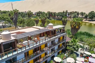 an aerial view of a hotel with a body of water at Banana's Adventure Hostel in Ica