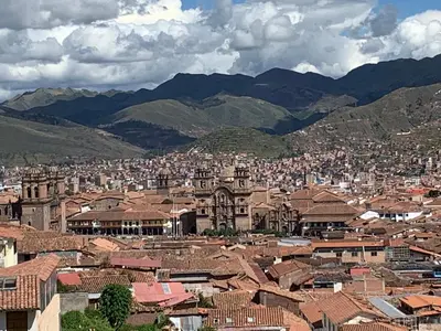 a view of a city with mountains in the background at Qolqampata Hotel in Cusco
