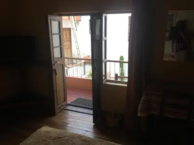 an open door in a room with a balcony at Posada Junco y Capuli in Huancayo